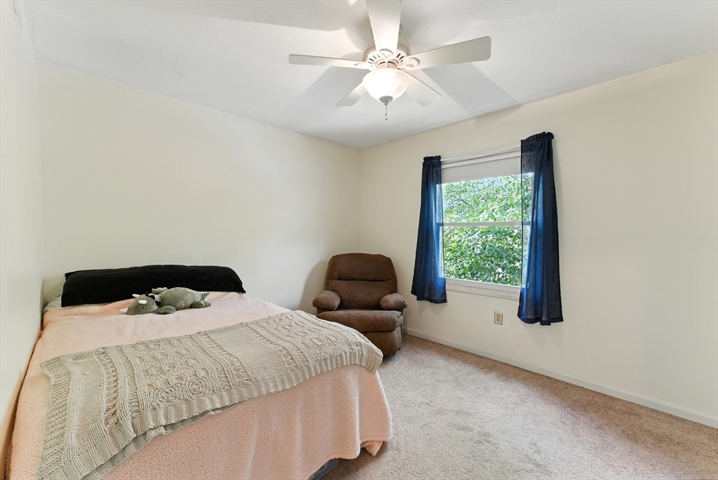 73 Yorktown Drive, Unit 73 Springfield, MA 01108 - Photo 20 of 42 a bedroom with two beds and ceiling fan