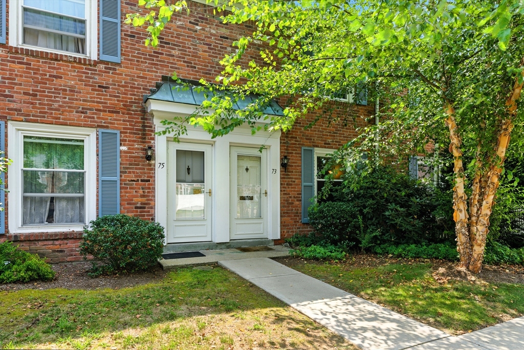 73 Yorktown Drive, Unit 73 Springfield, MA 01108 - Photo 2 of 42 a front view of a house with garden