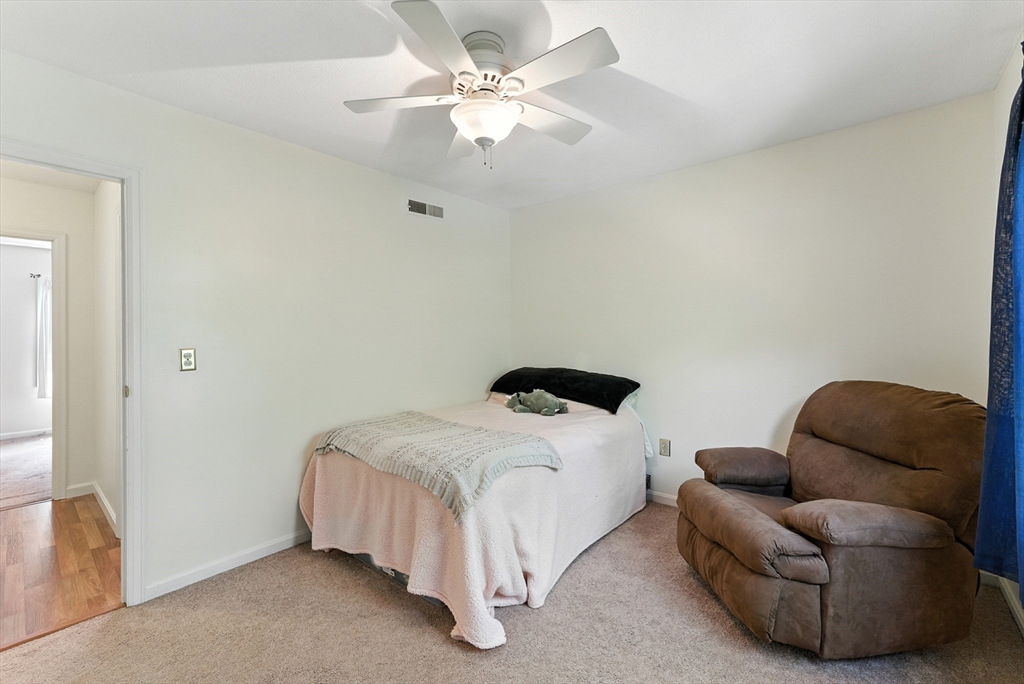 73 Yorktown Drive, Unit 73 Springfield, MA 01108 - Photo 21 of 42 a bedroom with a bed couch and a ceiling fan
