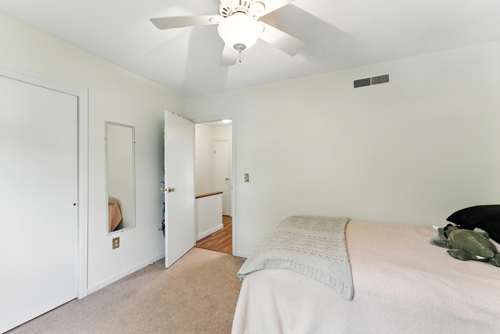 73 Yorktown Drive, Unit 73 Springfield, MA 01108 - Photo 22 of 42 a bedroom with a bed and a chandelier