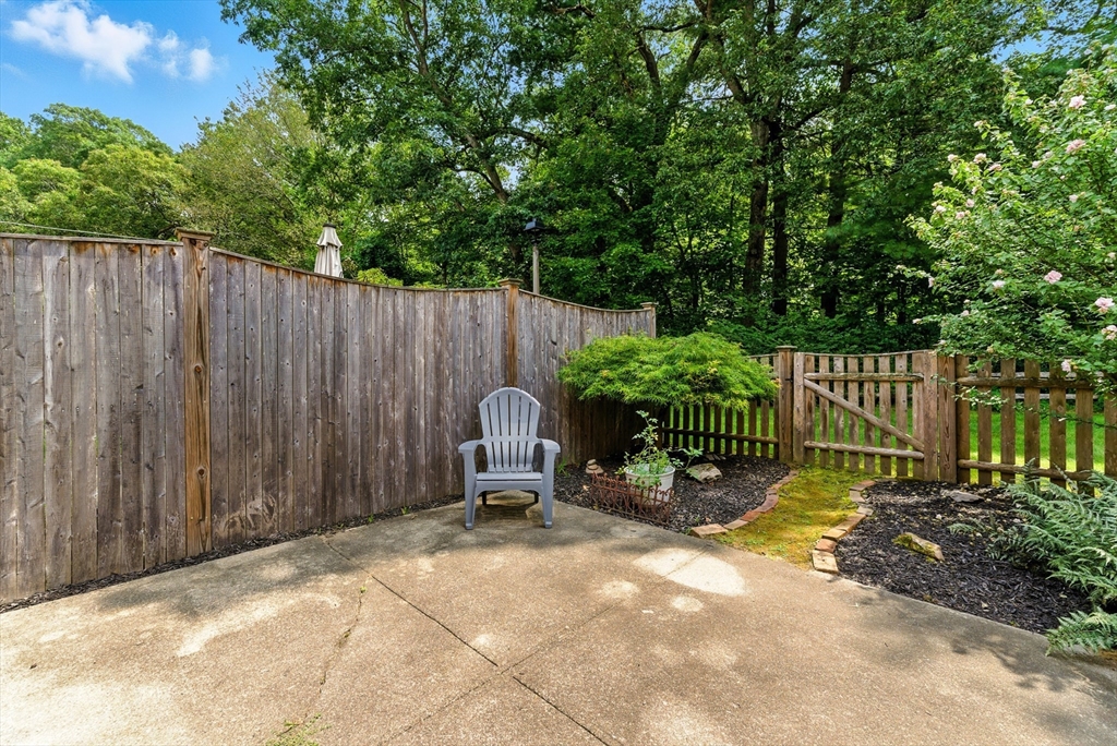 73 Yorktown Drive, Unit 73 Springfield, MA 01108 - Photo 24 of 42 a view of backyard with a fence and trees