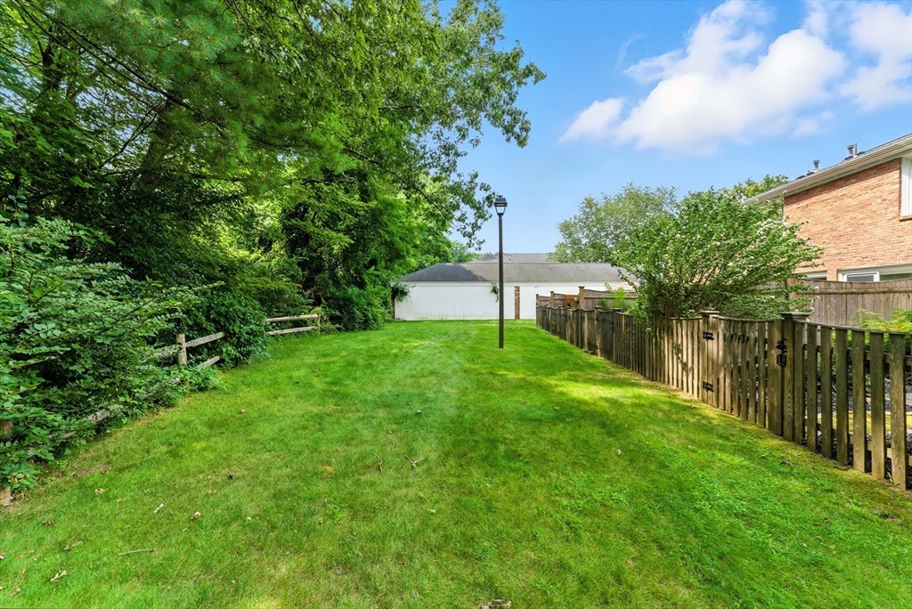 73 Yorktown Drive, Unit 73 Springfield, MA 01108 - Photo 31 of 42 a view of a backyard with a garden