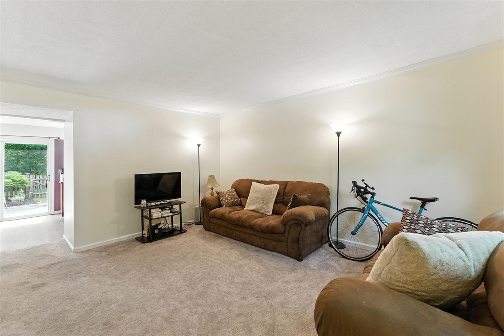 73 Yorktown Drive, Unit 73 Springfield, MA 01108 - Photo 6 of 42 a living room with furniture and a flat screen tv