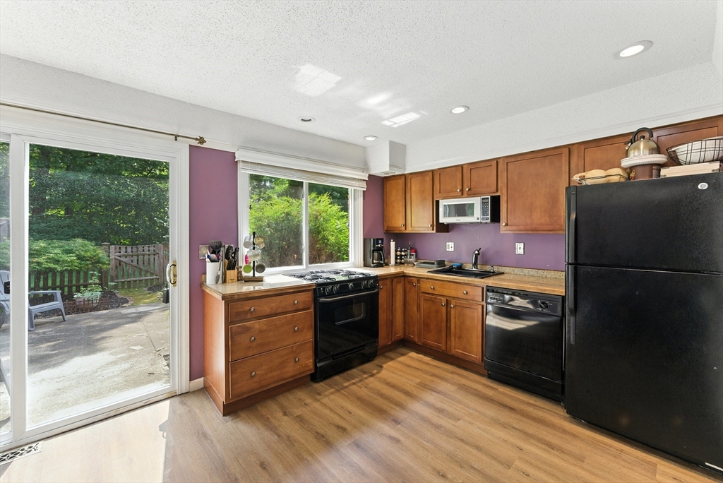 73 Yorktown Drive, Unit 73 Springfield, MA 01108 - Photo 8 of 42 a kitchen with granite countertop a refrigerator stove top oven and sink