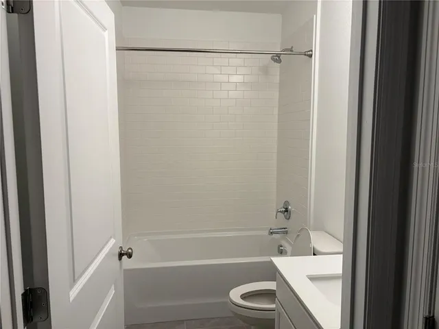 a bathroom with a shower a bathtub and a toilet