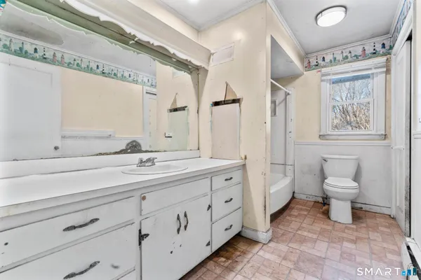 a spacious bathroom with a toilet sink and mirror
