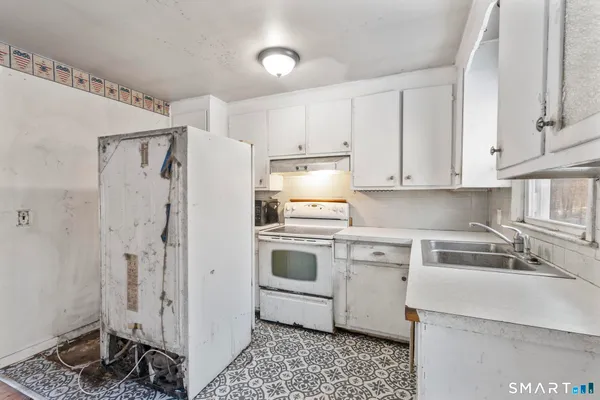 a kitchen with stainless steel appliances a refrigerator sink and cabinets