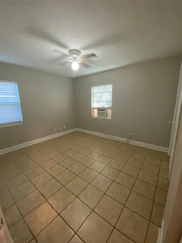 a view of a livingroom with an empty space and a window