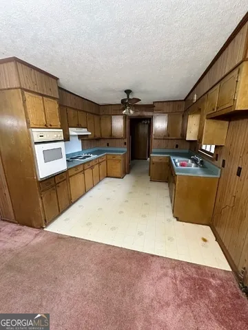 a kitchen with refrigerator and window