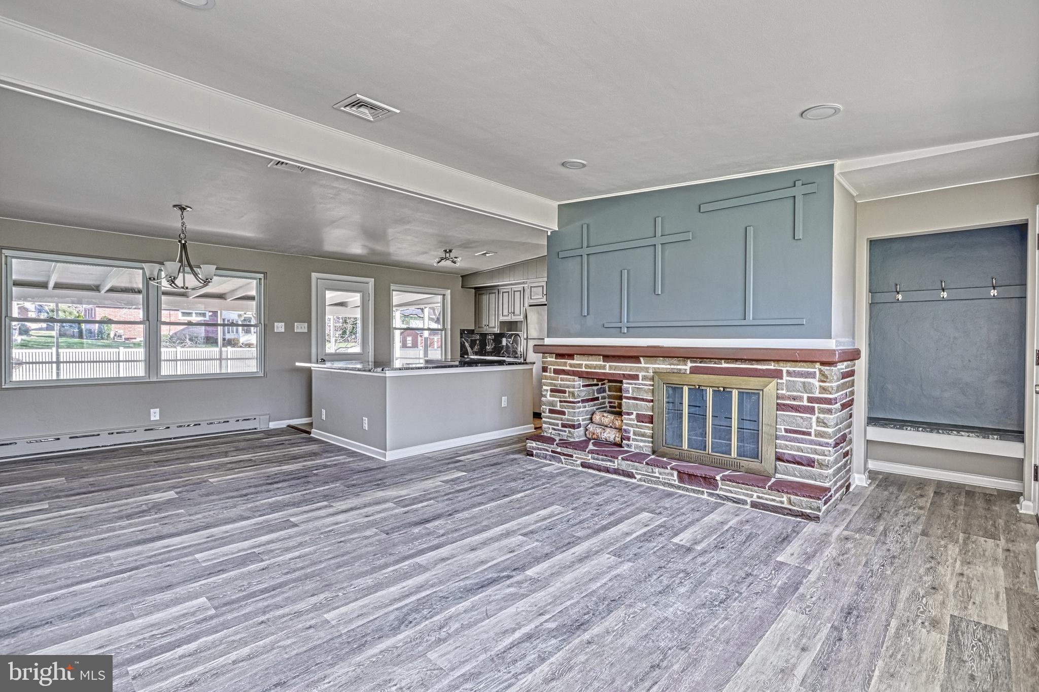 13 Cornell Drive Camp Hill, PA 17011 - Photo 11 of 76 an empty room with wooden floor fireplace and windows