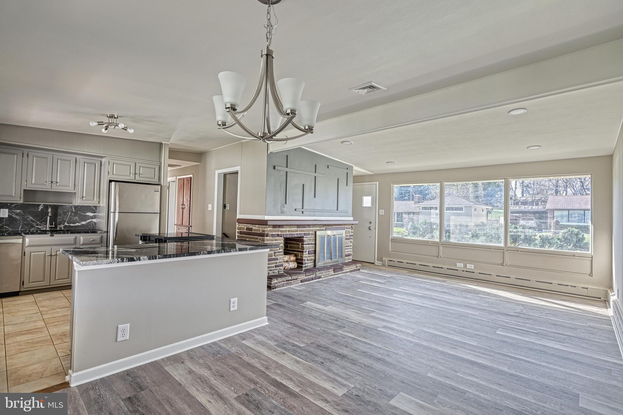 13 Cornell Drive Camp Hill, PA 17011 - Photo 17 of 76 a view of a kitchen with stainless steel appliances granite countertop a stove top oven a refrigerator a sink and dishwasher with wooden floor