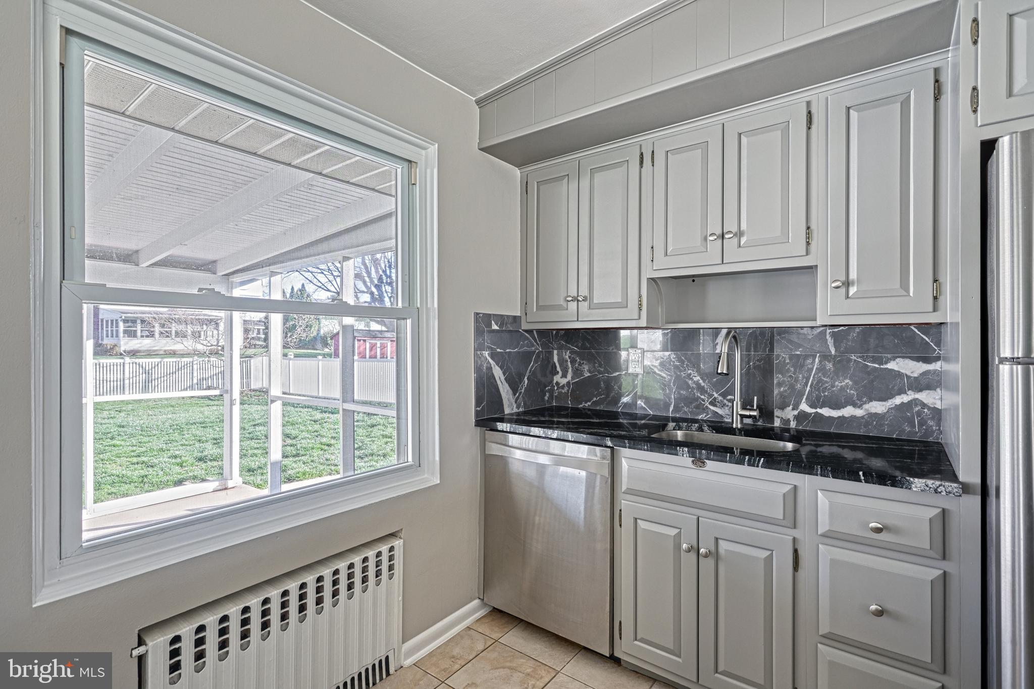13 Cornell Drive Camp Hill, PA 17011 - Photo 26 of 76 a kitchen with stainless steel appliances granite countertop white cabinets and a window