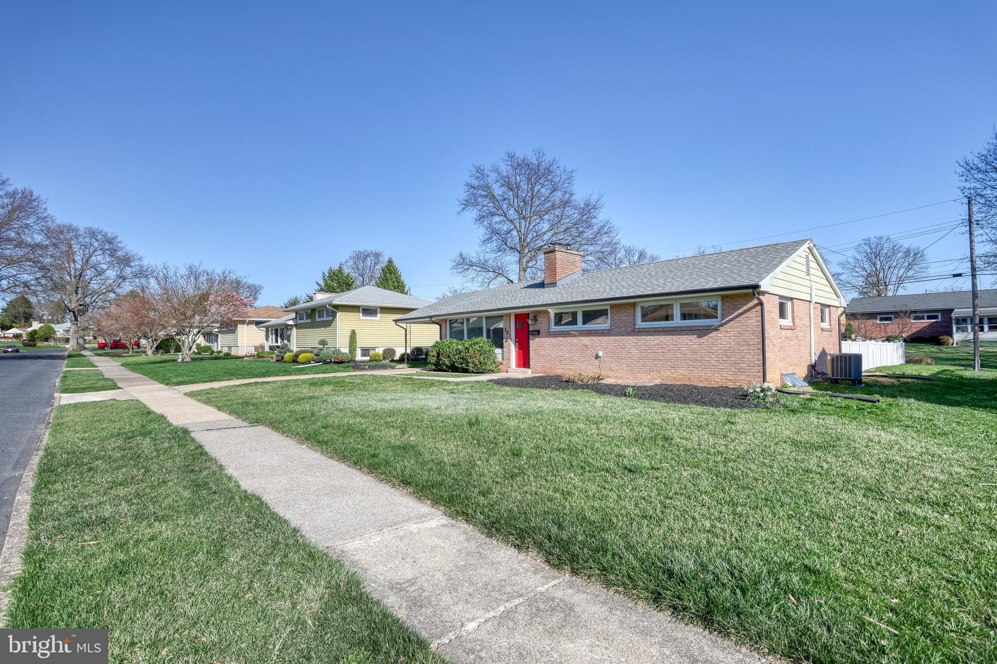 13 Cornell Drive Camp Hill, PA 17011 - Photo 4 of 76 a view of a white house with a big yard and large trees
