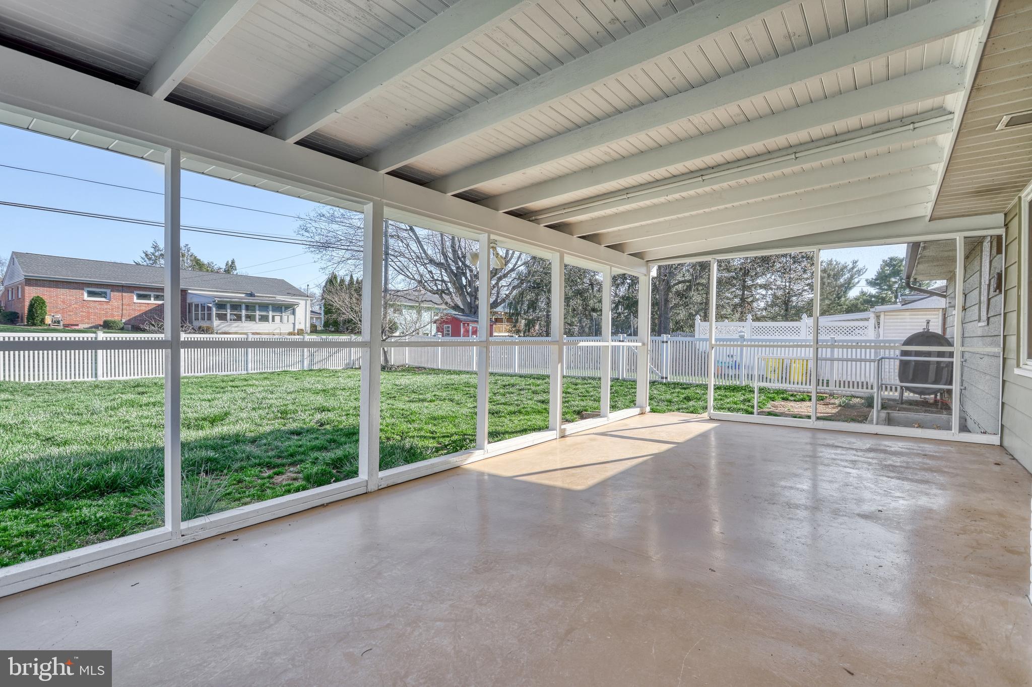 13 Cornell Drive Camp Hill, PA 17011 - Photo 48 of 76 a view of an empty room with floor to ceiling windows and yard