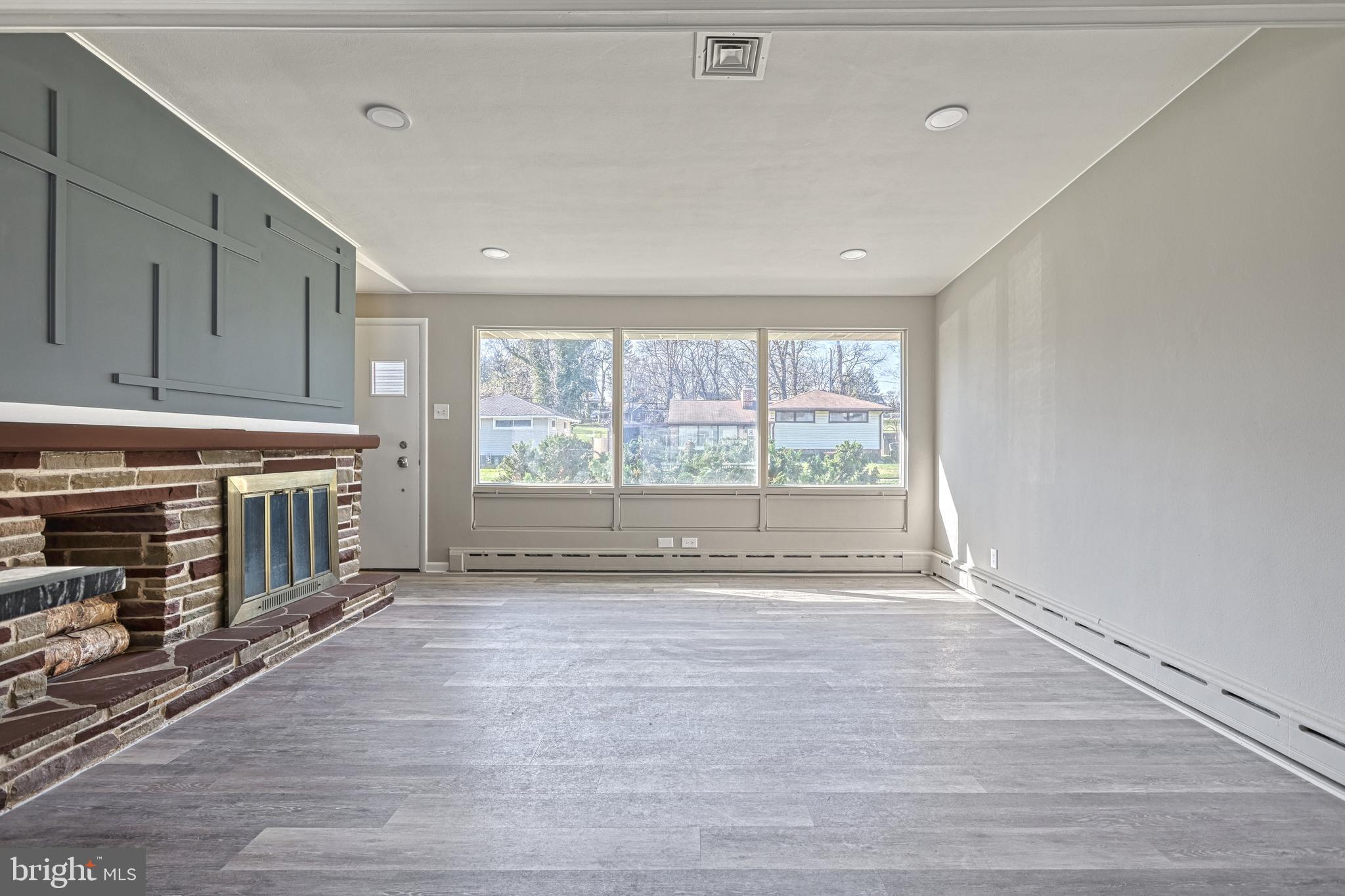 13 Cornell Drive Camp Hill, PA 17011 - Photo 9 of 76 a view of an empty room with a window and wooden floor