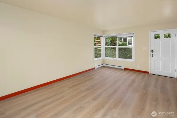 a view of empty room with wooden floor