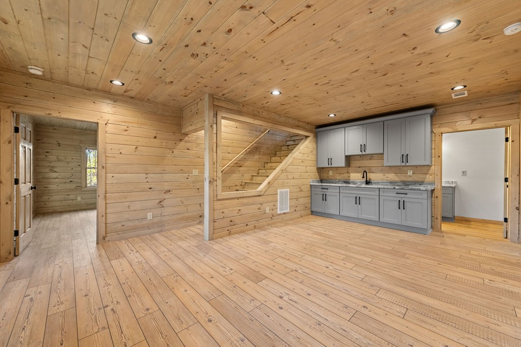 343 Windy Valley Trail Blue Ridge, GA 30513 - Photo 24 of 49 a large kitchen with wooden floors and wooden cabinets