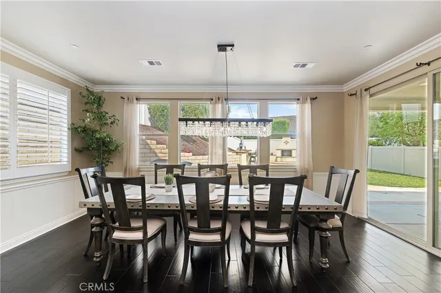 a spacious bedroom with a bed and a chandelier