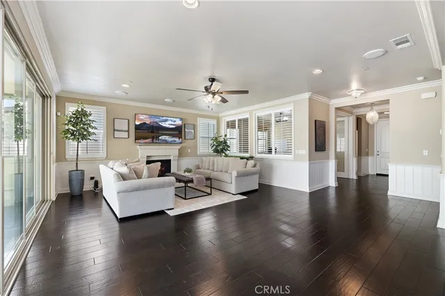 a living room with furniture and a ceiling fan