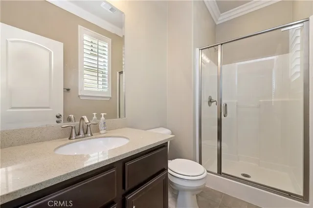 a bathroom with a double vanity sink toilet and a mirror
