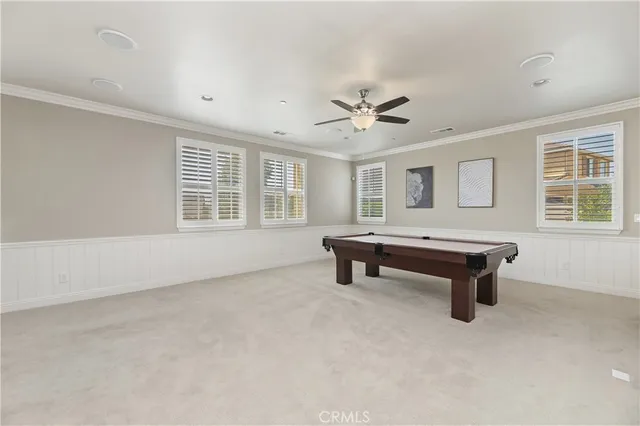 a view of a white house with a big yard and potted plants