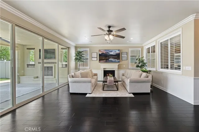 a kitchen with stainless steel appliances kitchen island granite countertop a table chairs and wooden floor