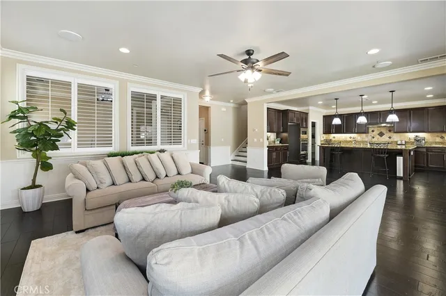 a kitchen with kitchen island granite countertop a sink a counter top stainless steel appliances and cabinets