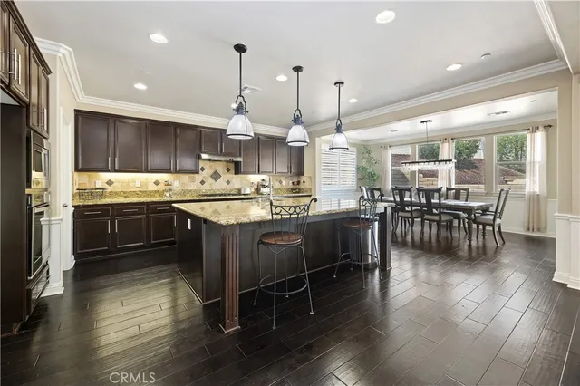 a view of a kitchen counter top space with furniture and floor to ceiling window