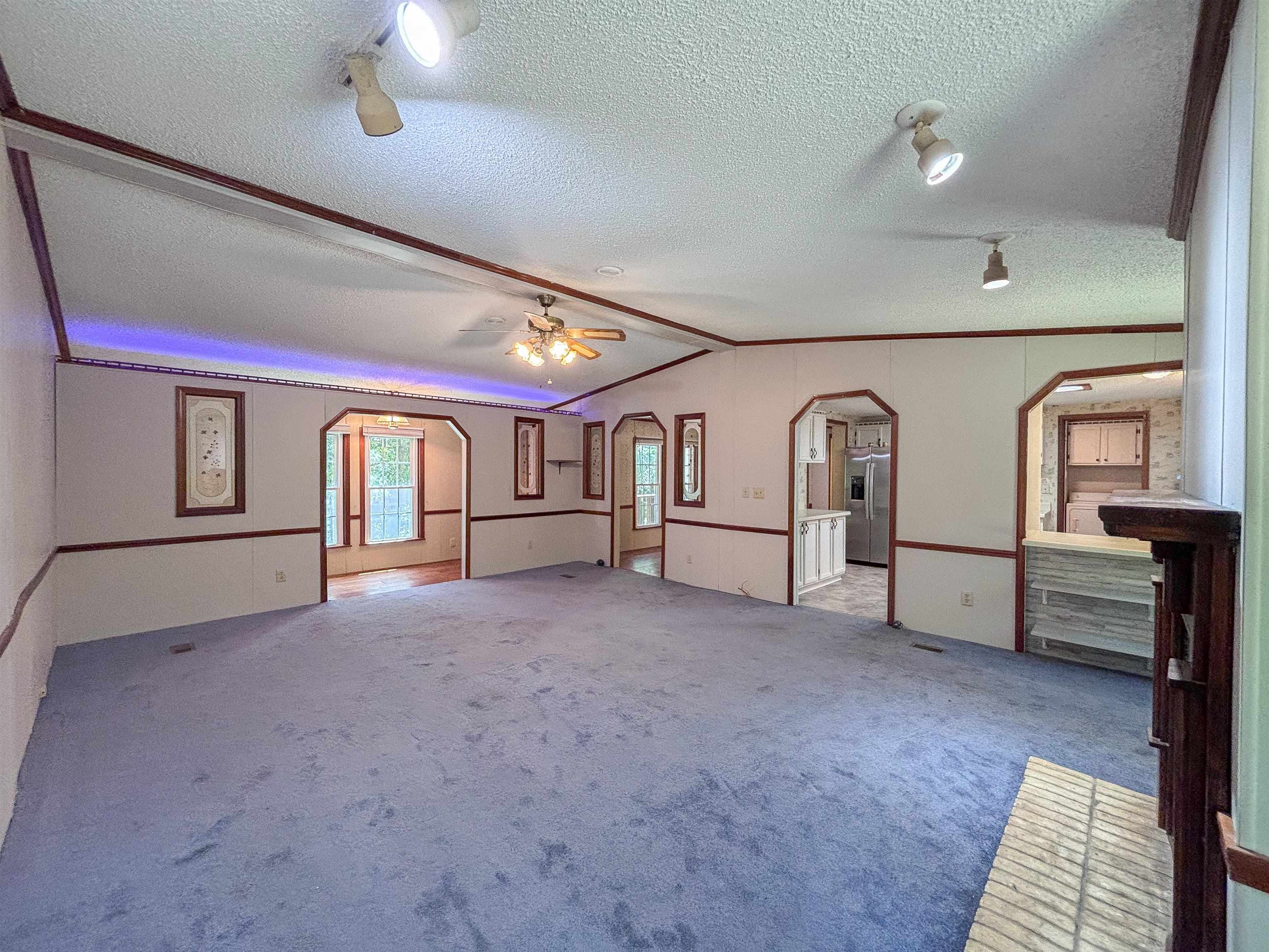 471 Milton Road Millington, TN 38053 - Photo 9 of 30 Spacious interior featuring blue carpeting, a ceiling fan, and track lighting