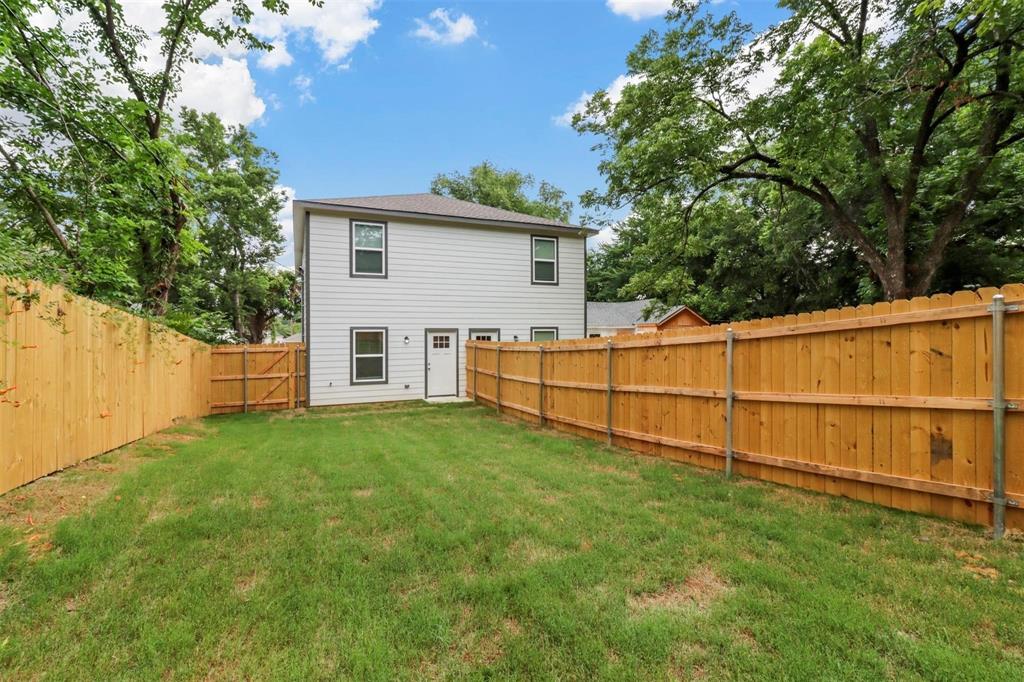 312 East Shepherd Street, Unit 312 Denison, TX 75021 - Photo 15 of 15 a view of backyard with wooden fence and large trees