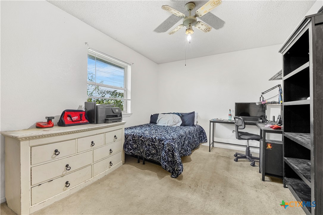 3216 Wendy Lane Kempner, TX 76539 - Photo 13 of 23 a bedroom with a bed and a chandelier