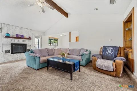 an empty room with furniture and a fireplace