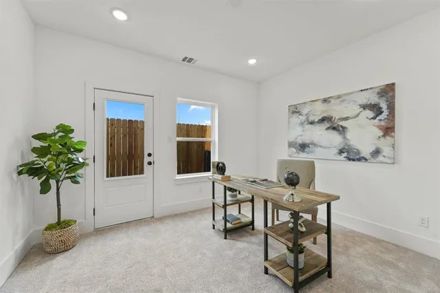 a living room with furniture and potted plant