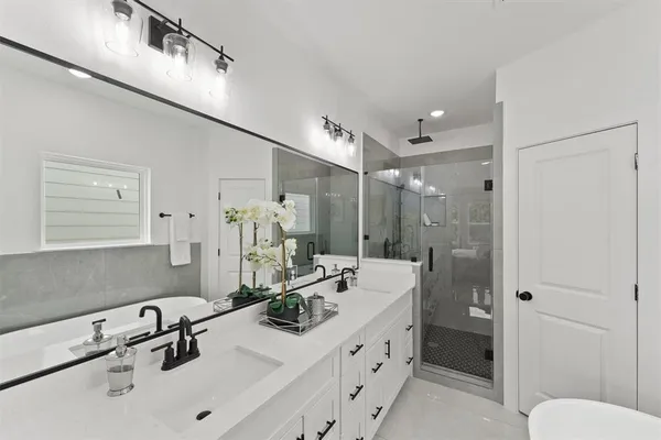 a bathroom with a sink double vanity and a shower