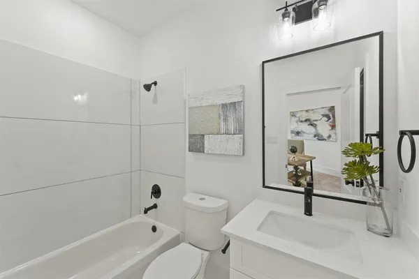 a bathroom with a shower a toilet and a bathtub