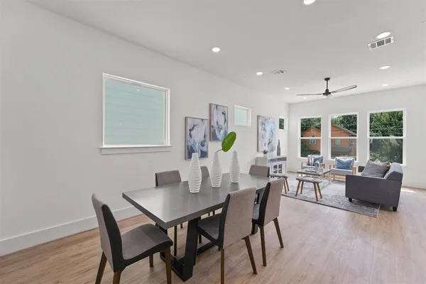 a view of a dining room with furniture and wooden floor