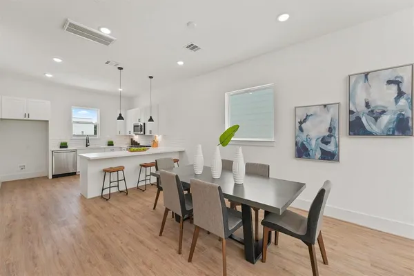 a view of a dining room with furniture and wooden floor