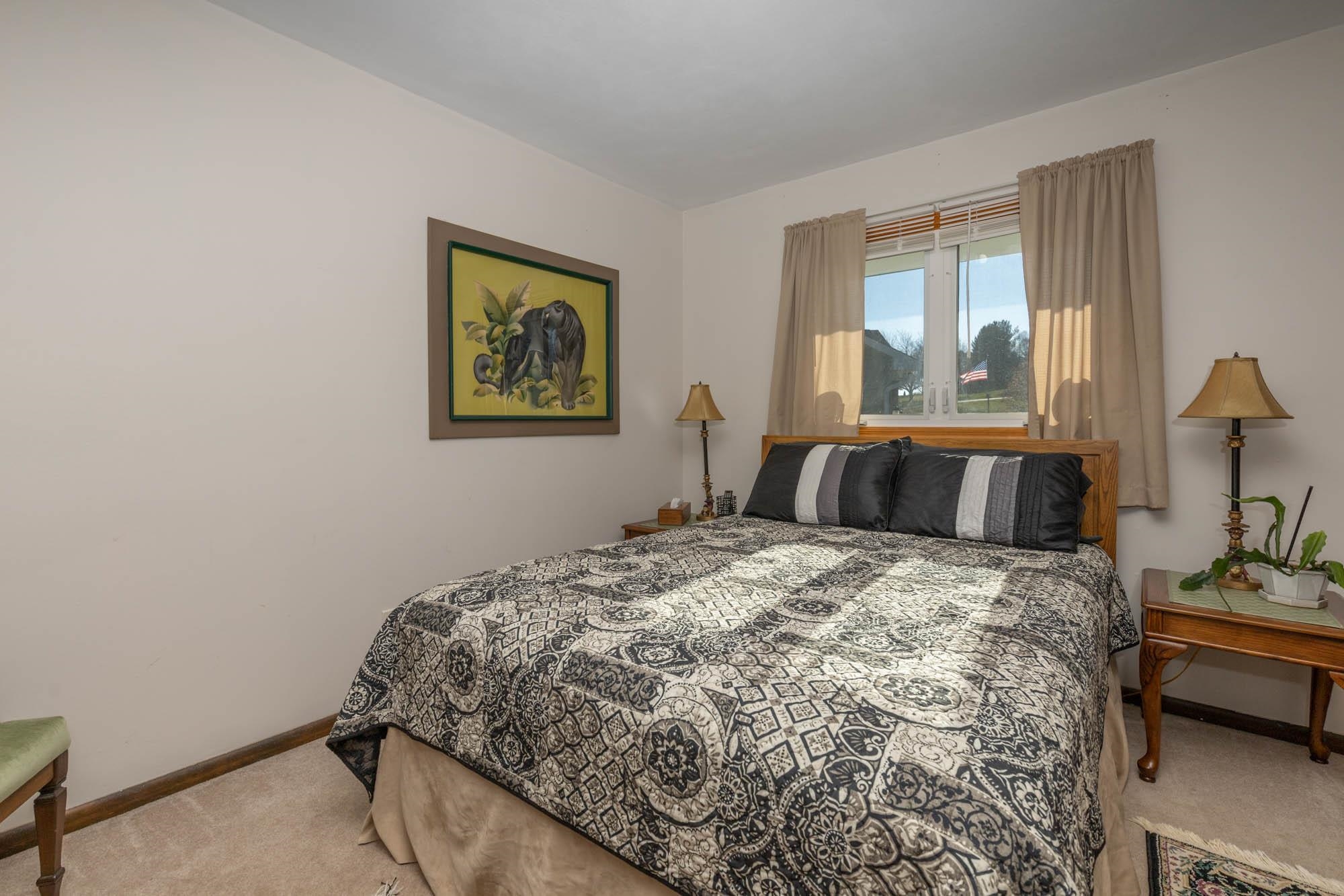 90 Lake Summerset Road Lake Summerset, IL 61019 - Photo 15 of 35 a bedroom with a bed and a dresser next to a window