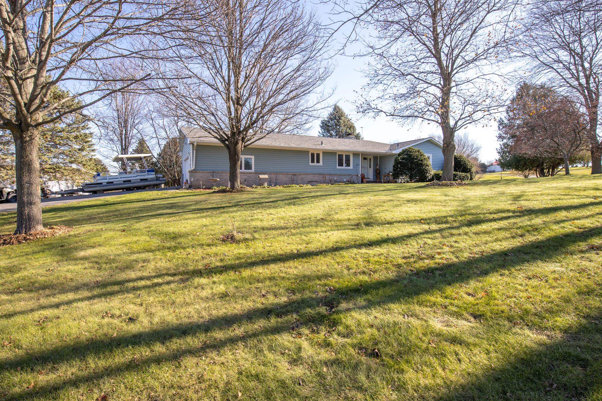 90 Lake Summerset Road Lake Summerset, IL 61019 - Photo 2 of 35 a view of a house with a big yard and large trees