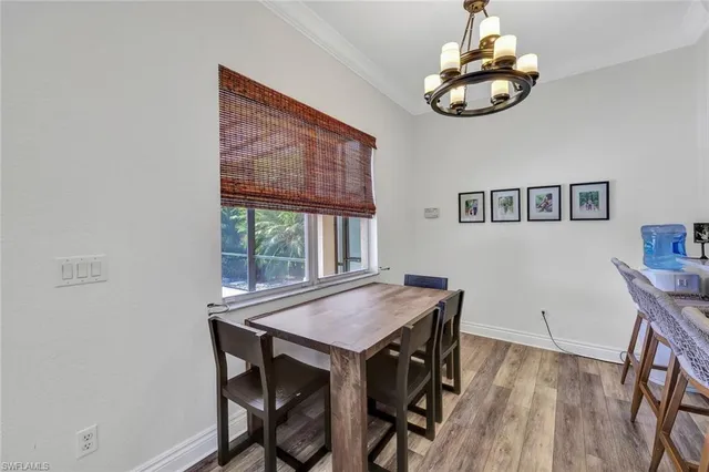 a view of a dining room with furniture wooden floor and chandelier