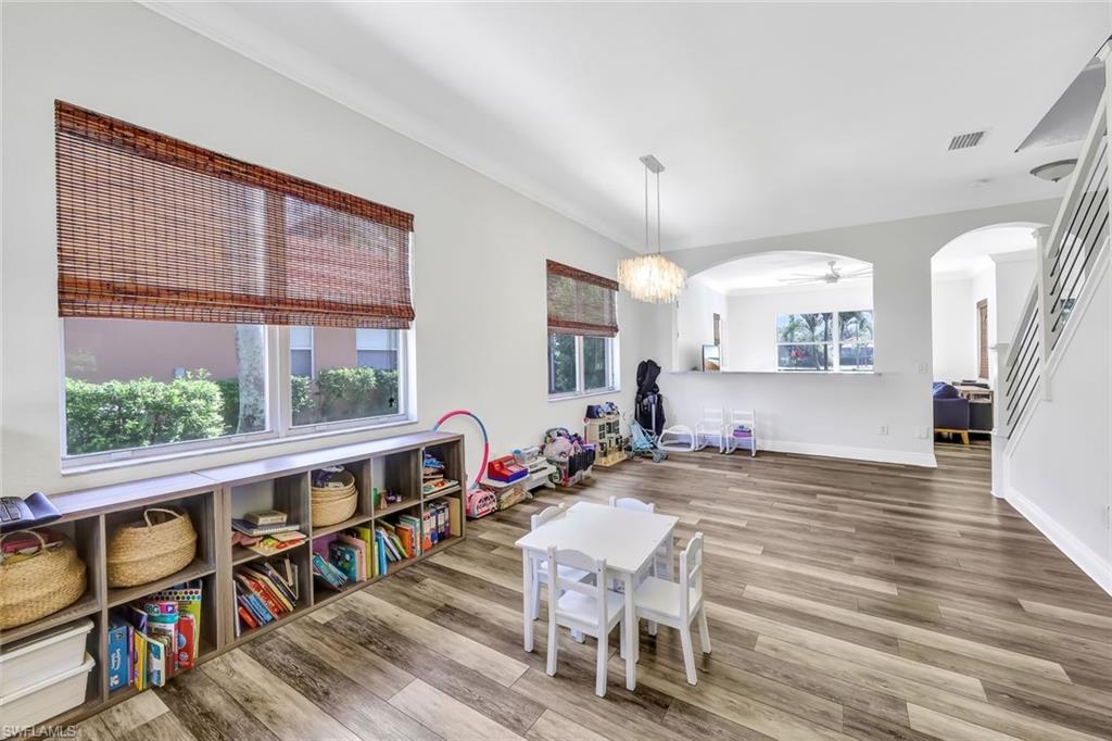 1949 Par Drive Naples, FL 34120 - Photo 13 of 39 a living room with furniture a rug potted plant and a large window
