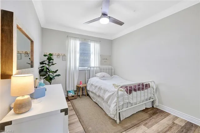 a bedroom with a bed and a potted plant
