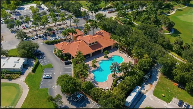 an aerial view of residential house with outdoor space and swimming pool