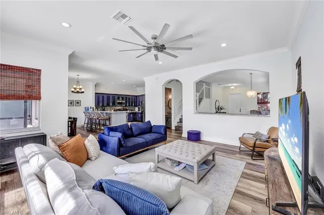 a living room with furniture ceiling fan and a rug