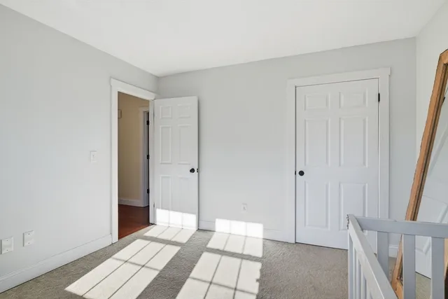 a view of an empty room and wooden floor
