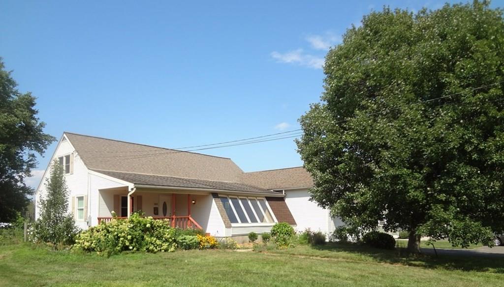 109 New Ludlow Road Granby, MA 01033 - Photo 1 of 42 a front view of a house with a garden