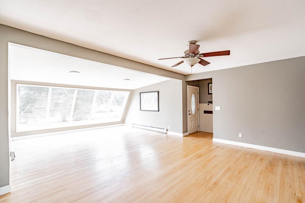 109 New Ludlow Road Granby, MA 01033 - Photo 11 of 42 a view of an empty room with a window and wooden floor