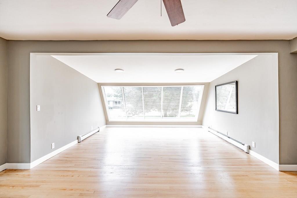 109 New Ludlow Road Granby, MA 01033 - Photo 13 of 42 a view of an empty room with wooden floor and a window