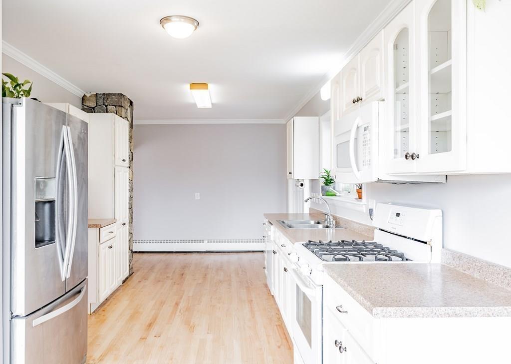 109 New Ludlow Road Granby, MA 01033 - Photo 16 of 42 a kitchen with granite countertop a sink stove and refrigerator