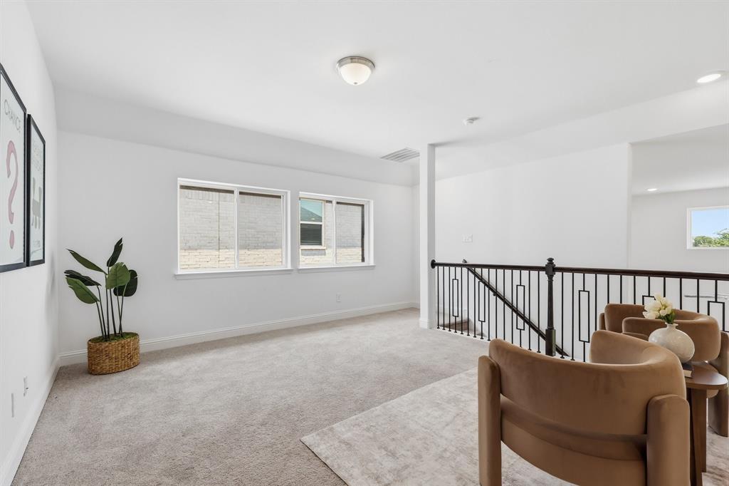 539 Farrell Lane Allen, TX 75013 - Photo 21 of 39 Spacious upper-level landing featuring light-colored carpeting, multiple windows, a modern metal baluster railing, and recessed ceiling lighting